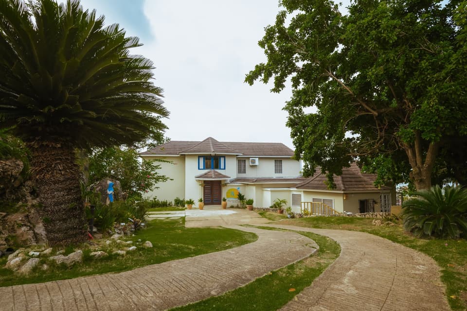 The brick driveway and gardens leading to Bay Vista Villa on Shaw Park Ridge