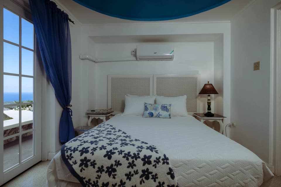 The Forget-Me-Not Cozy Room at Bay Vista Villa with its deep-blue domed ceiling and white bed