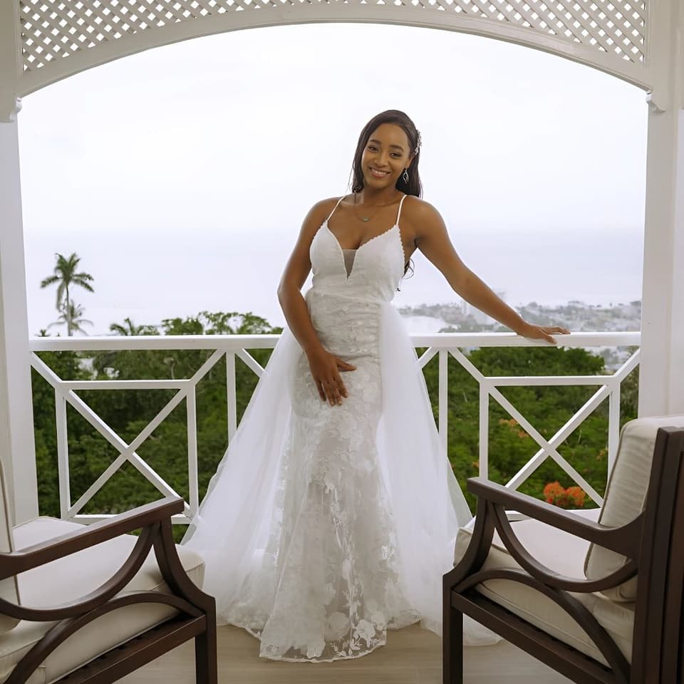 A bride on the balcony at Bay Vista Villa with Ocho Rios and the sea behind her