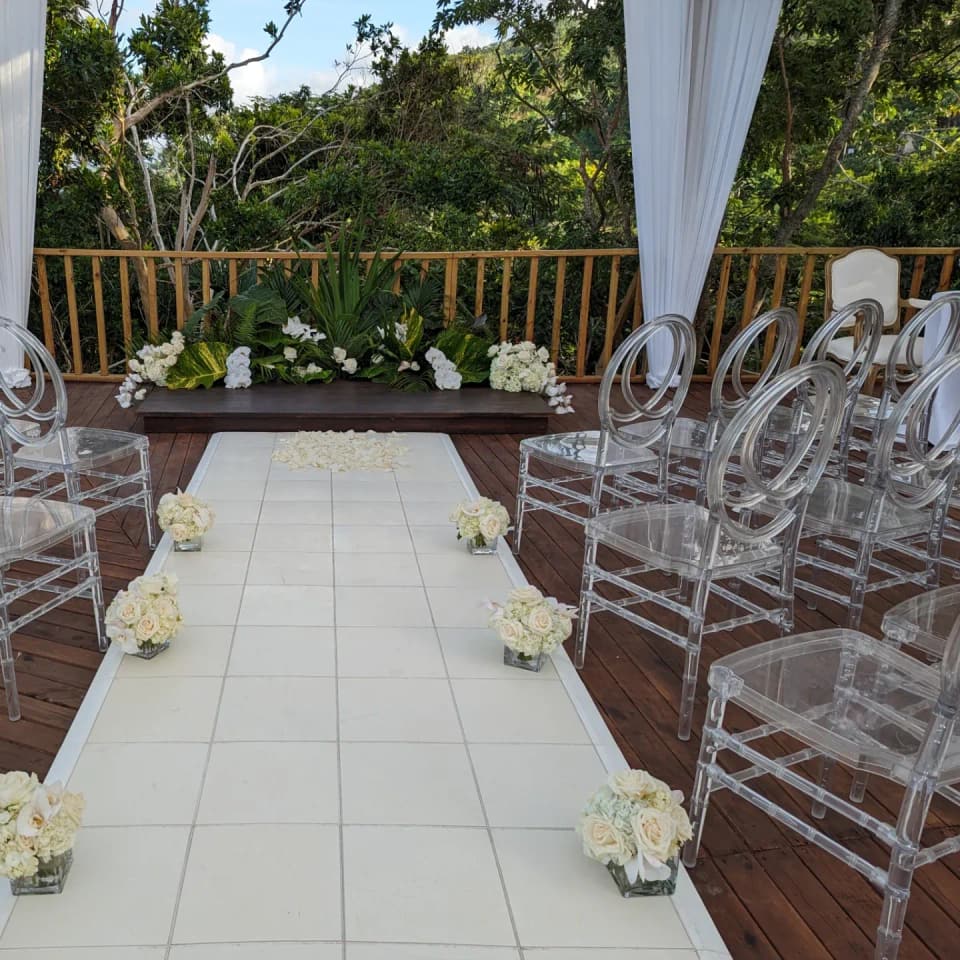 Clear acrylic chairs and a white aisle on the deck at Bay Vista Villa