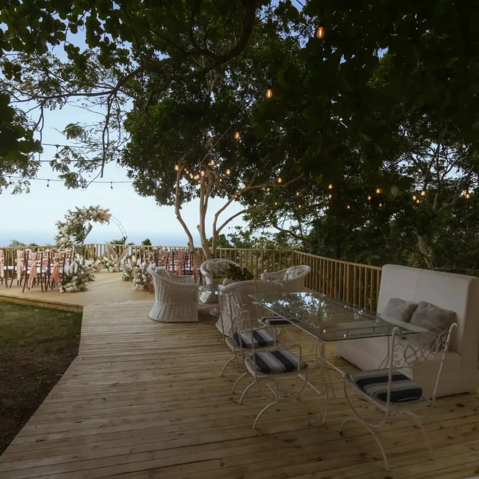The deck at Bay Vista Villa at dusk, lanterns lit, set for a wedding ceremony