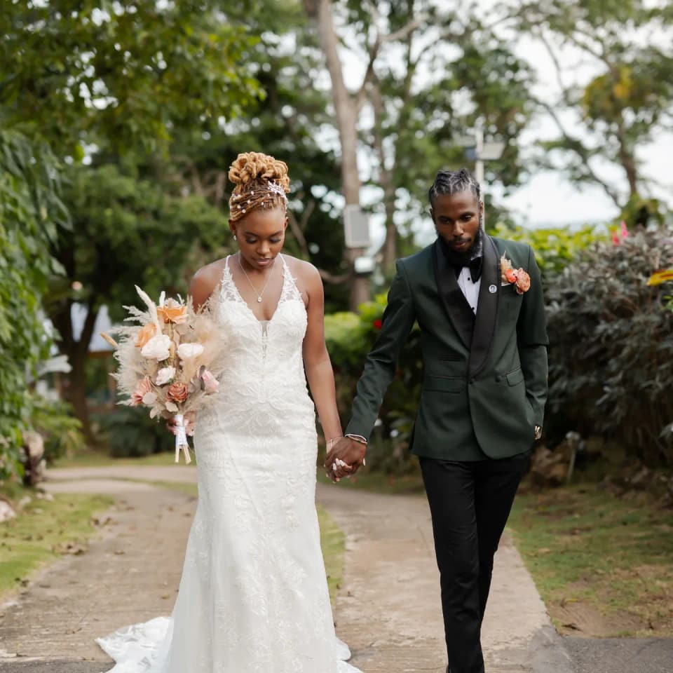 Newlyweds walking the garden path at Bay Vista Villa