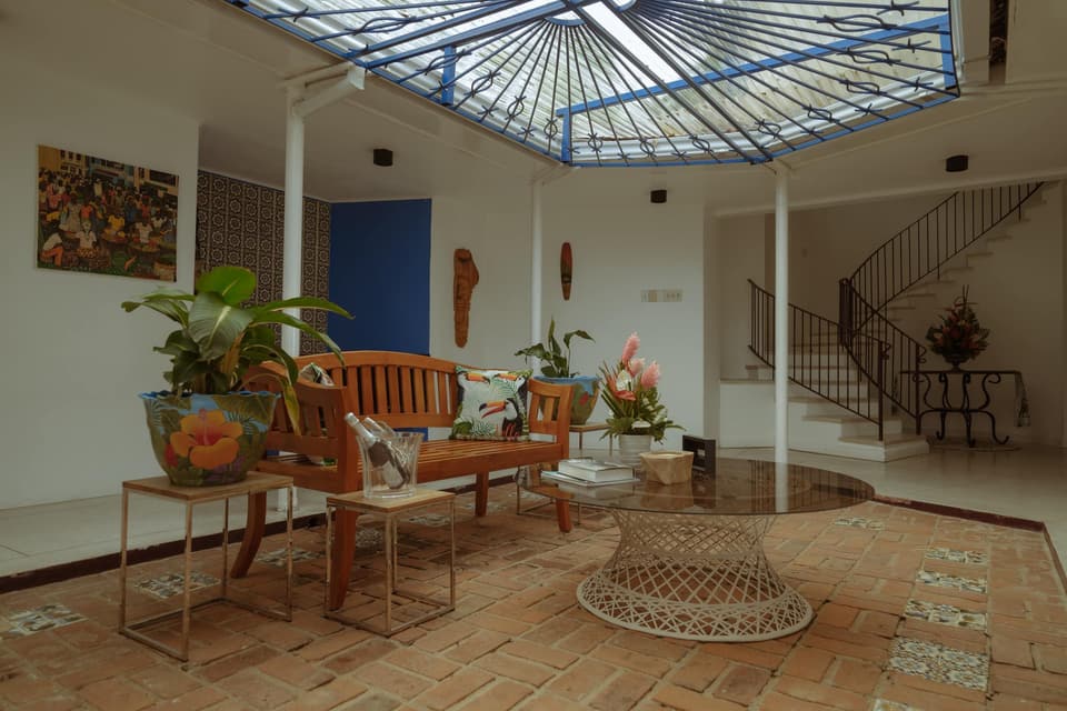 The red-brick garden courtyard at the centre of Bay Vista Villa, under a clear skylight
