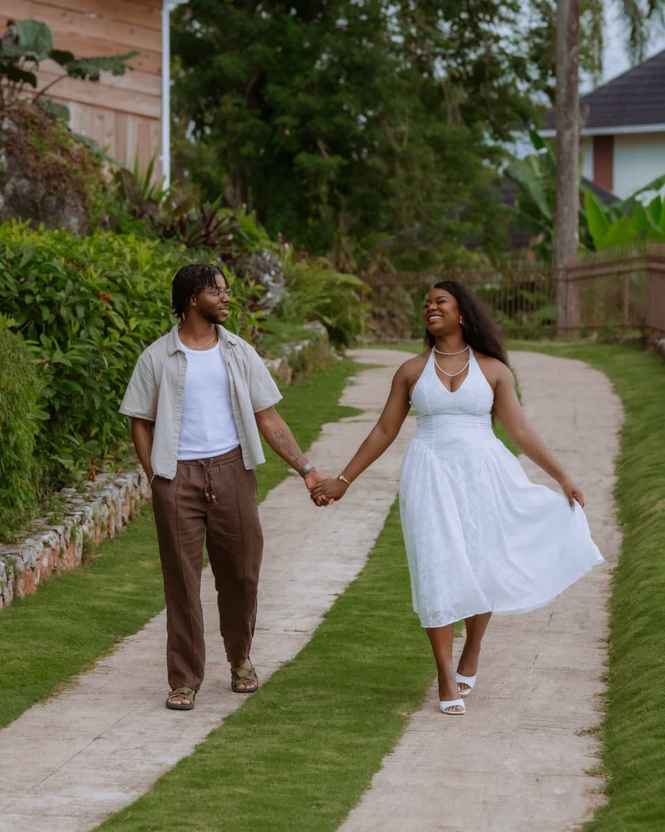 A couple walking hand in hand along the brick path at Bay Vista Villa