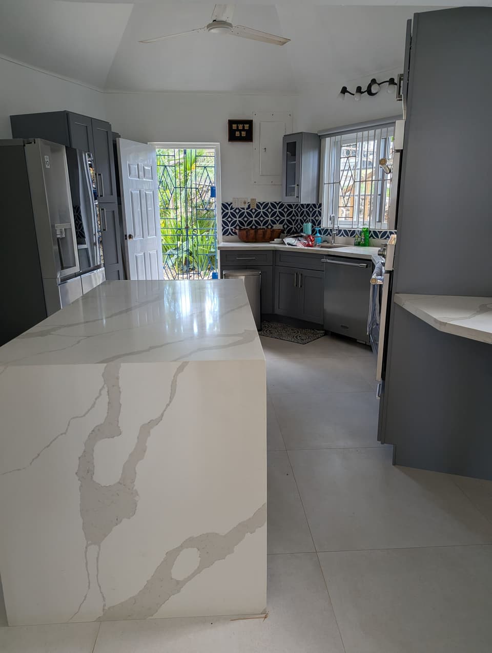 The kitchen at Bay Vista Villa with its quartz island and grey cabinetry