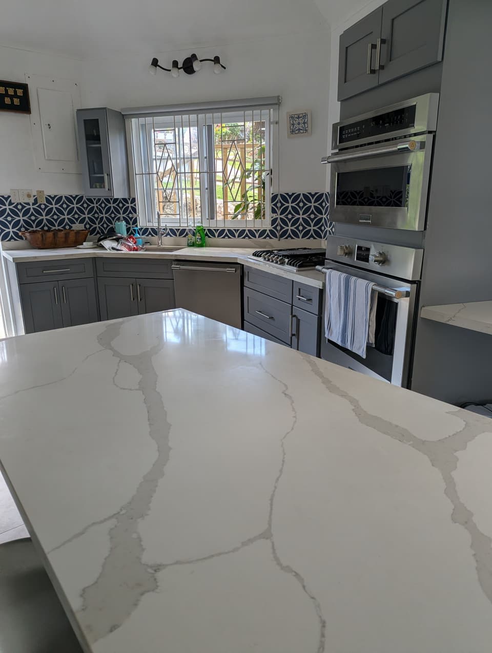 The quartz island, stove and dishwasher in the kitchen at Bay Vista Villa