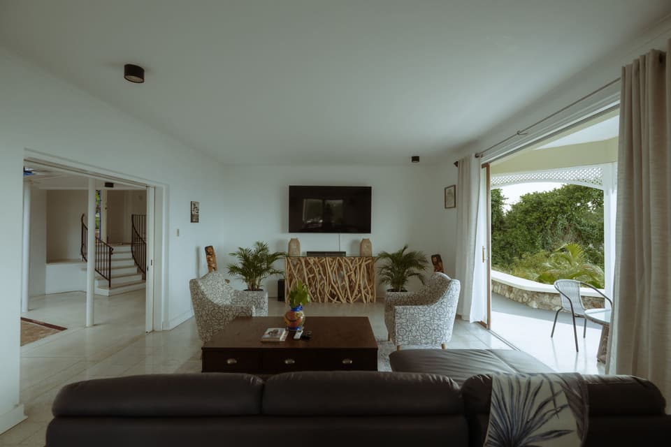 The living room at Bay Vista Villa opening onto the veranda and the view
