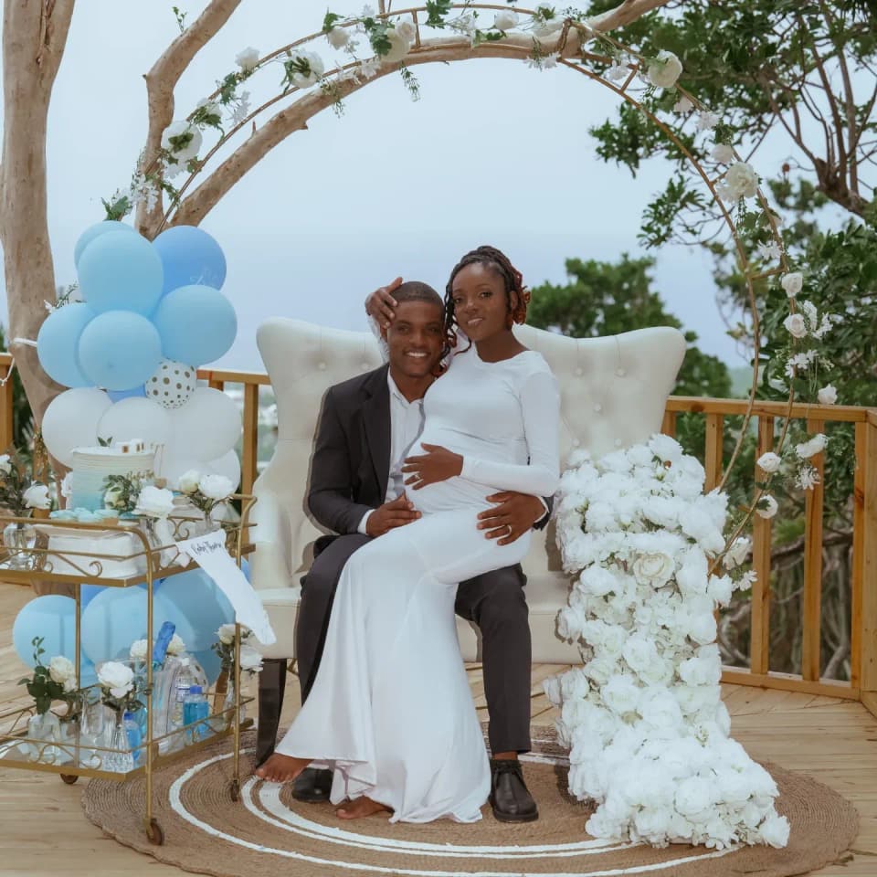 A maternity celebration on the deck at Bay Vista Villa with blue balloons and white flowers
