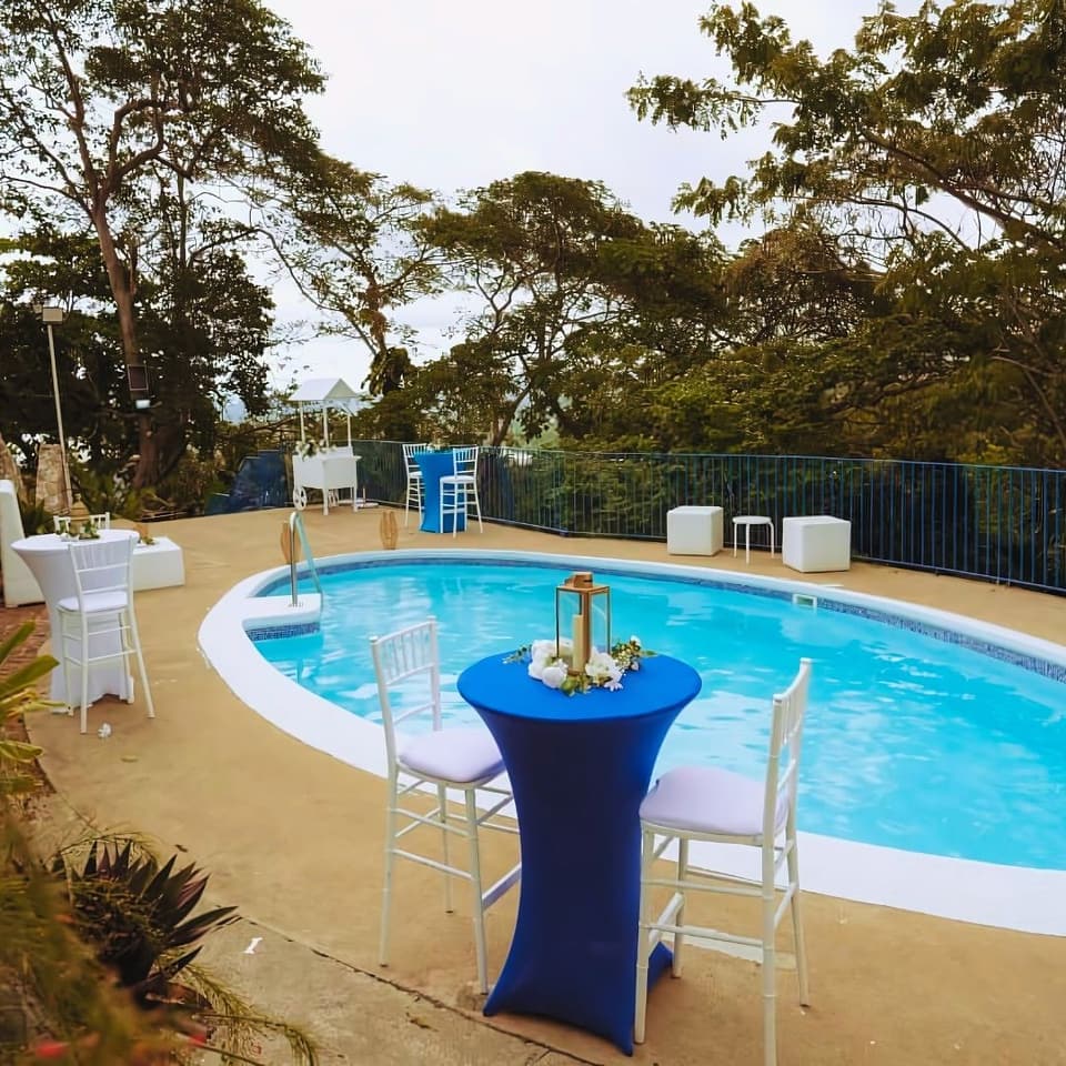 The oval pool at Bay Vista Villa with a cocktail table set for a reception