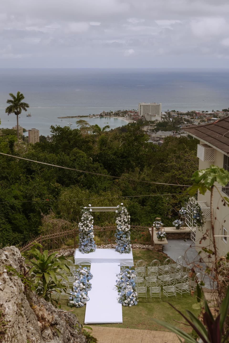 Dusk over Ocho Rios from the deck at Bay Vista Villa, with a floral arch set for a ceremony