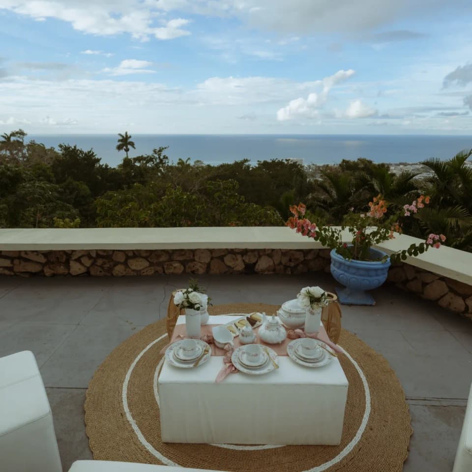 The cut-stone terrace wall at Bay Vista Villa with the coast of Ocho Rios in the distance